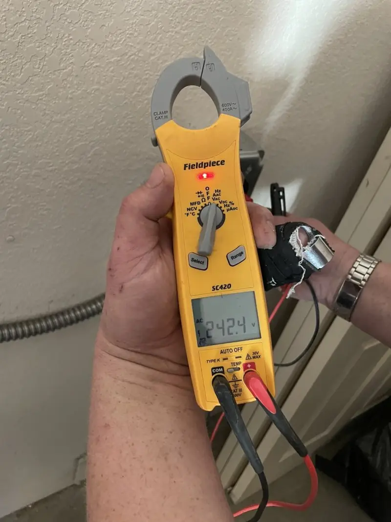 Voltage testing with clamp meter during Ceiling Fan Installation in Wynne